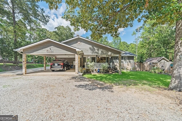 view of front of home with covered porch, a front yard, and a carport