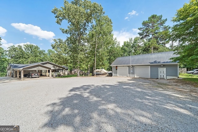 view of home's exterior with a carport and a garage