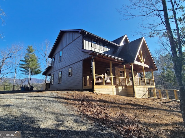 view of side of property featuring covered porch