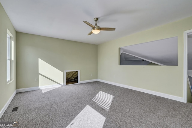 carpeted spare room with ceiling fan