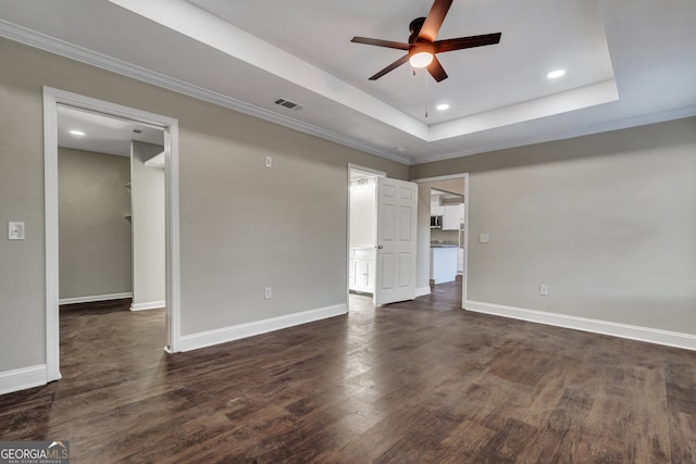 spare room with crown molding, a raised ceiling, ceiling fan, and dark hardwood / wood-style flooring