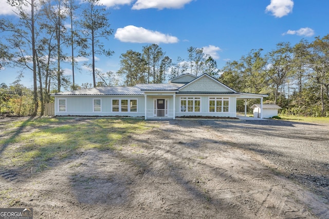 view of front of property featuring a storage shed