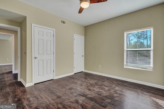 unfurnished bedroom featuring dark wood-type flooring and ceiling fan