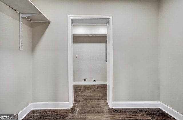 clothes washing area featuring dark hardwood / wood-style floors