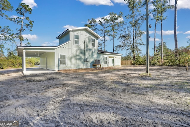 back of property with a carport