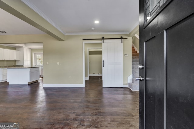 interior space featuring ornamental molding, dark hardwood / wood-style floors, and a barn door