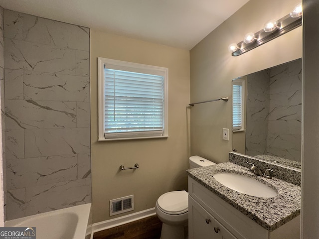 bathroom with visible vents, vanity, wood finished floors, toilet, and a bathtub