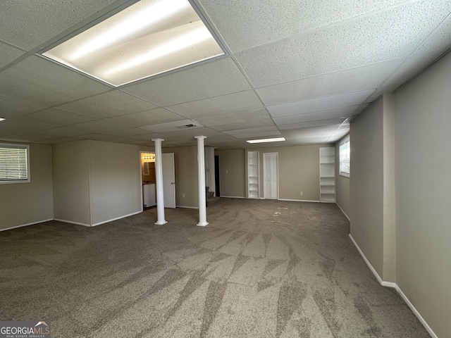 basement with carpet floors and a drop ceiling