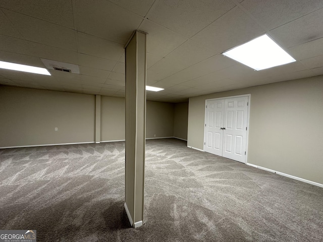 finished below grade area with carpet floors, baseboards, and visible vents