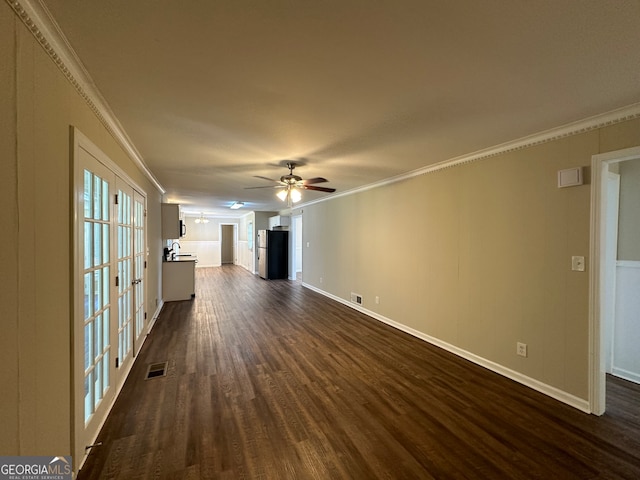 unfurnished living room featuring ceiling fan, dark hardwood / wood-style flooring, ornamental molding, french doors, and sink