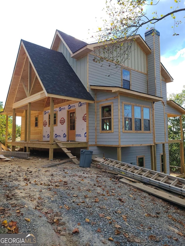 rear view of house featuring covered porch