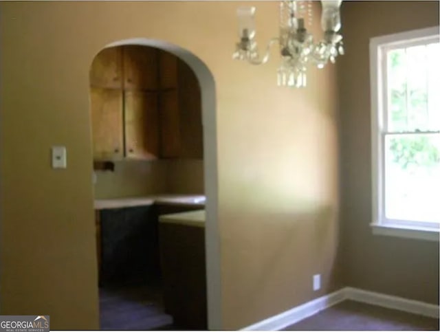 dining space featuring an inviting chandelier and a healthy amount of sunlight