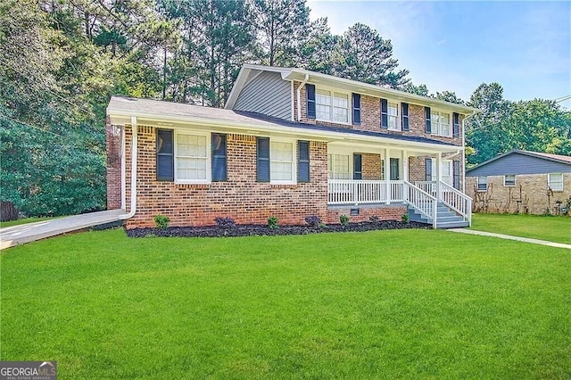 view of front of property with covered porch and a front lawn