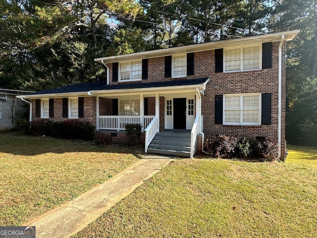 view of front of property with covered porch and a front yard