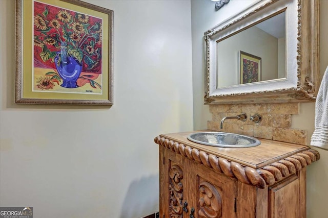 bathroom with vanity and decorative backsplash