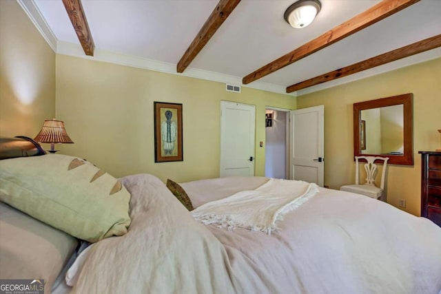 bedroom with beam ceiling and crown molding