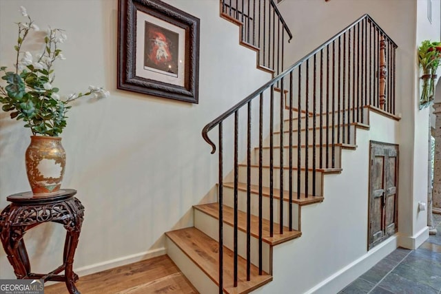 stairs featuring wood-type flooring