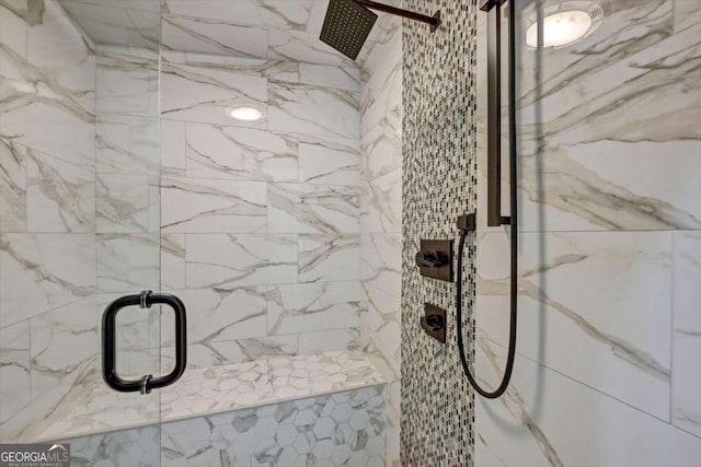 bathroom featuring a shower with shower door