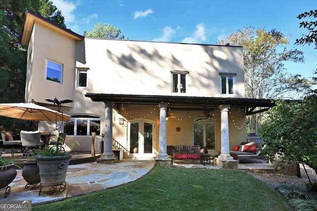 back of house featuring a patio area, french doors, an outdoor hangout area, ceiling fan, and a lawn