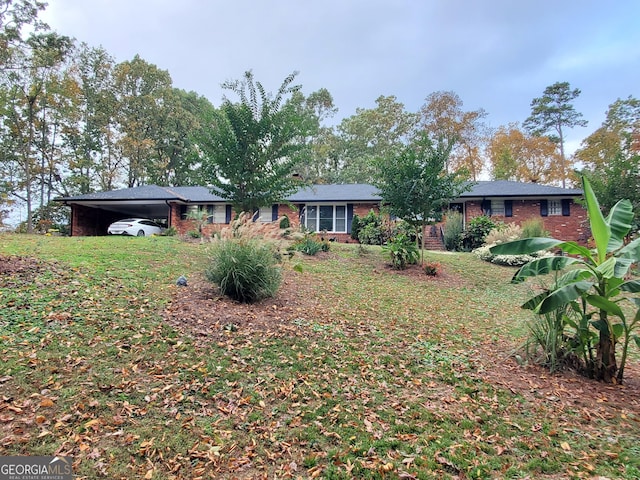 view of front of house featuring an attached carport and brick siding