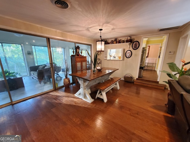 dining space featuring crown molding, visible vents, and wood finished floors