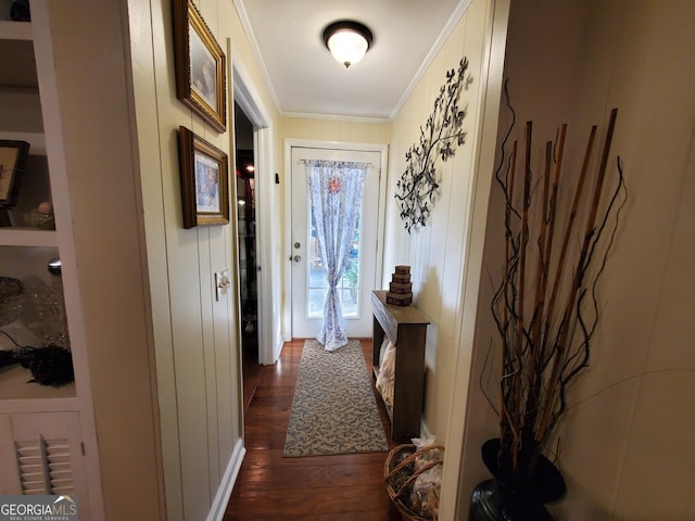 doorway featuring dark wood-type flooring and crown molding