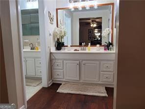 bathroom featuring a ceiling fan, wood finished floors, and vanity