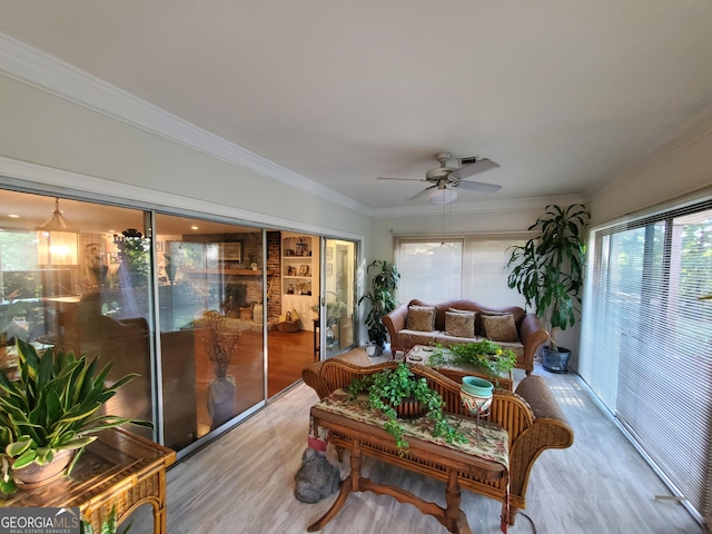 sunroom / solarium featuring a ceiling fan