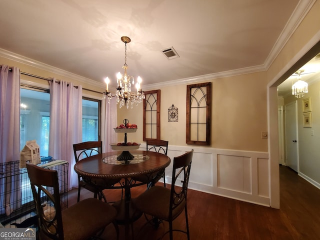 dining room with dark wood-type flooring, a chandelier, and crown molding