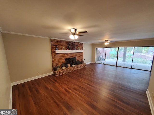 unfurnished living room featuring ornamental molding, a fireplace, dark wood-type flooring, and ceiling fan