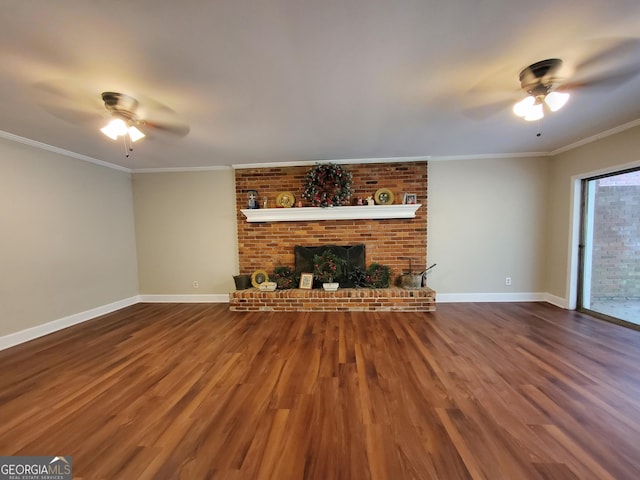 unfurnished living room featuring a fireplace, wood finished floors, a ceiling fan, baseboards, and crown molding