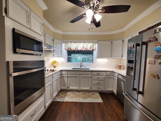 kitchen with stainless steel appliances, white cabinets, sink, and dark wood-type flooring