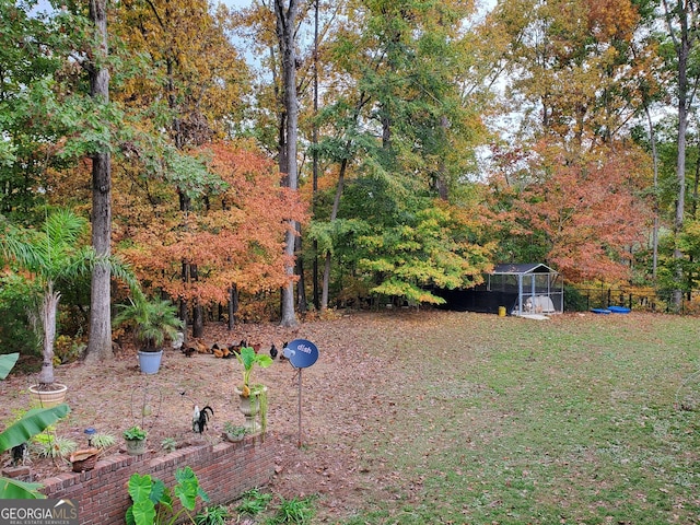 view of yard with an outbuilding and fence