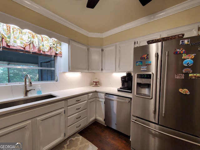 kitchen with crown molding, stainless steel appliances, dark hardwood / wood-style flooring, sink, and white cabinets