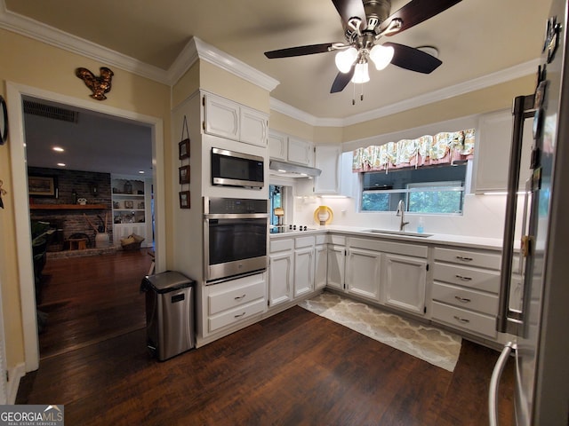 kitchen with stainless steel appliances, a sink, and ornamental molding