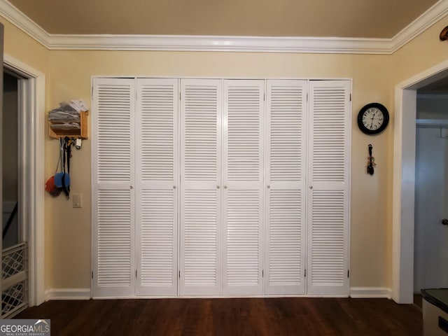 interior details with ornamental molding, baseboards, and wood finished floors