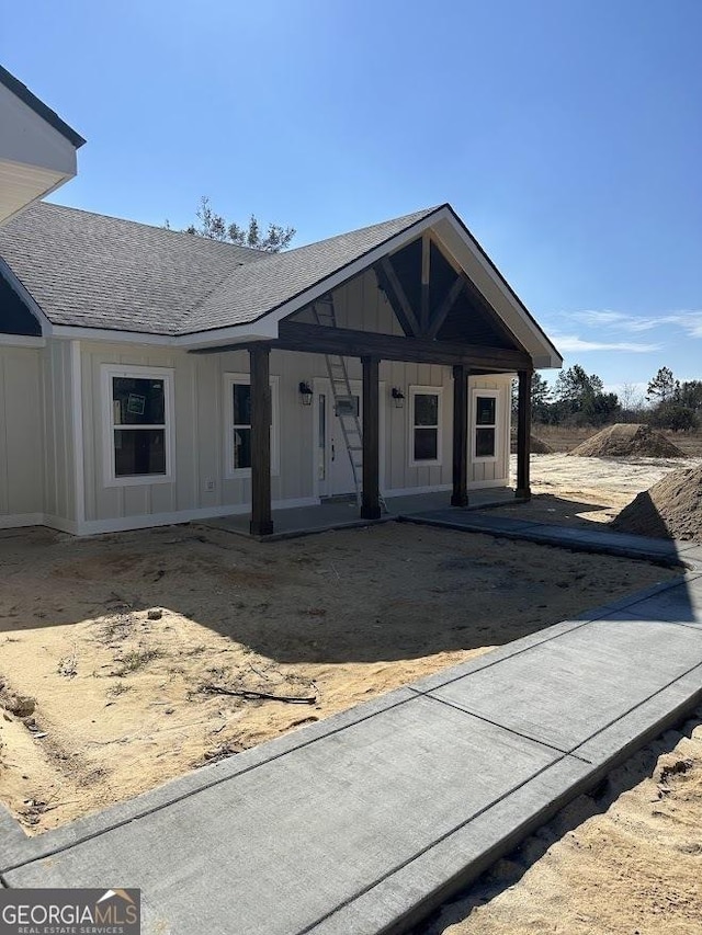 view of front of home featuring a porch, roof with shingles, and board and batten siding