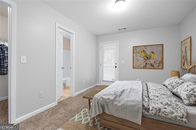 carpeted bedroom featuring ensuite bathroom