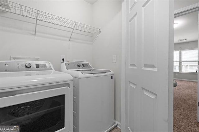 laundry room featuring washer and dryer and carpet flooring