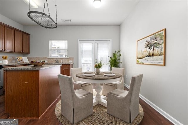 dining room with dark hardwood / wood-style flooring