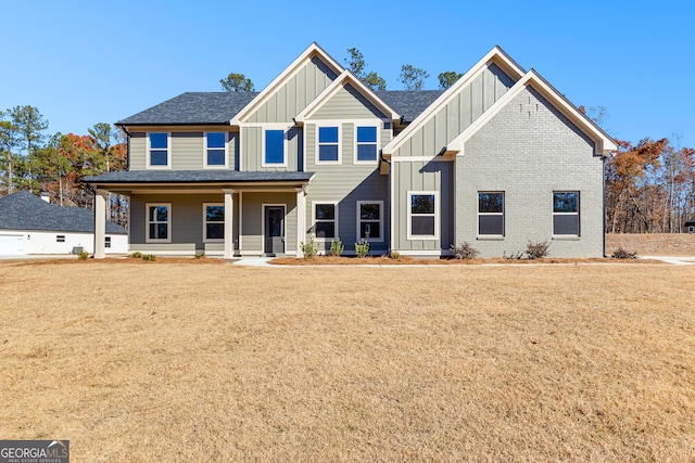 view of front of home with a porch and a front yard