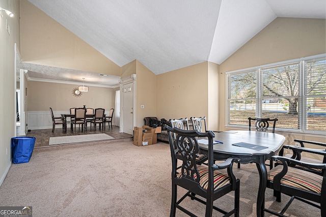 dining area with carpet flooring, lofted ceiling, a textured ceiling, and a chandelier