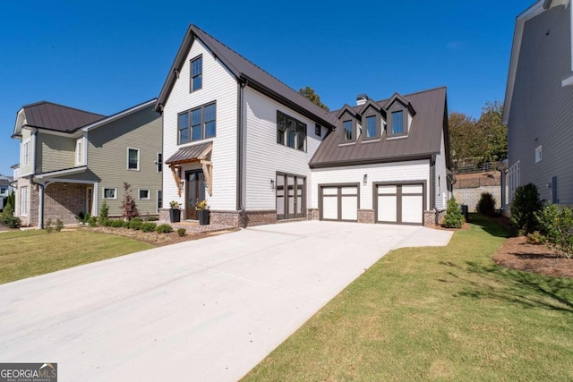 view of front of house featuring a front yard and a garage