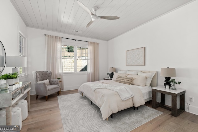 bedroom with wooden ceiling, ceiling fan, light wood-style flooring, and baseboards