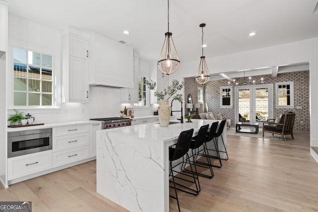 kitchen featuring light wood-style floors, appliances with stainless steel finishes, and white cabinets