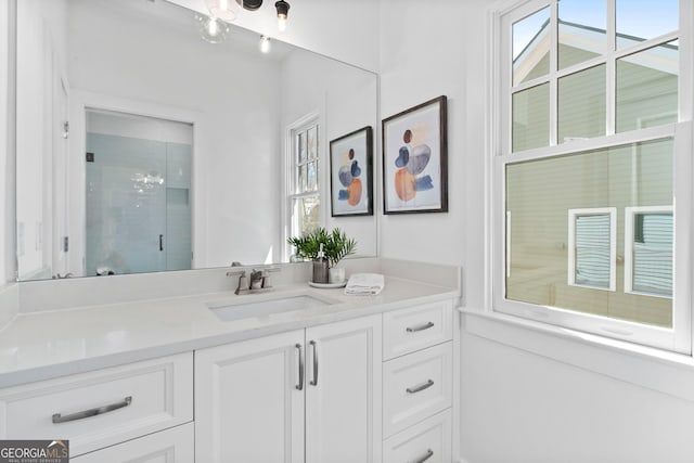 full bathroom with a shower with door and vanity