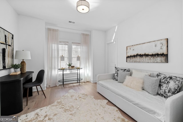 living room with visible vents and wood finished floors