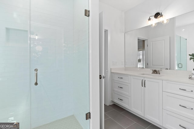 full bath with a stall shower, tile patterned flooring, and vanity