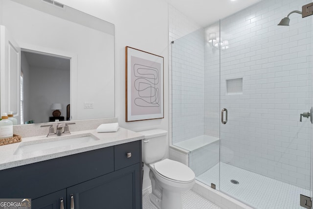 full bathroom featuring visible vents, toilet, tile patterned floors, vanity, and a shower stall