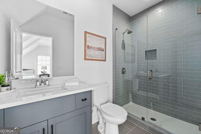 bathroom with toilet, a shower stall, and visible vents